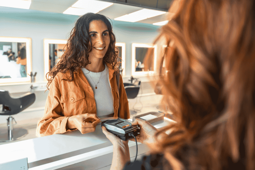 Customer paying with a card at a point-of-sale terminal, representing authorized user purchases and account monitoring