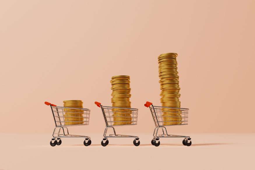Three small shopping carts filled with increasing stacks of gold coins, symbolizing rising costs