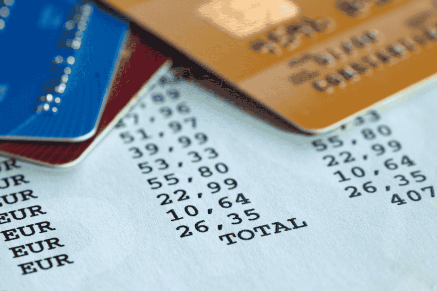 Receipt with total amounts in euros and multiple credit cards on top