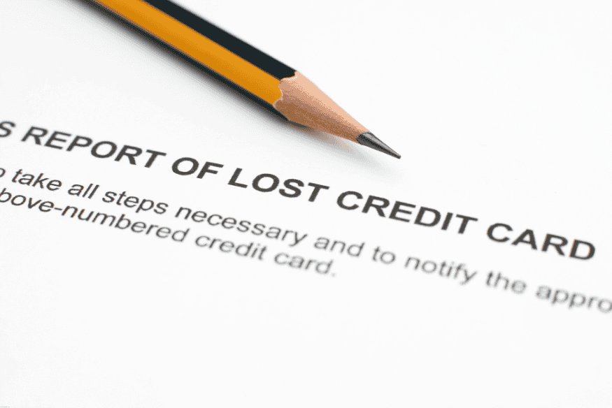 Close-up of a lost credit card report form with pencil on paper